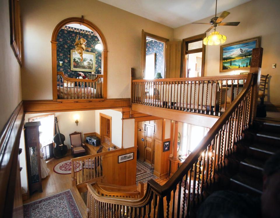 Three types of stair spindles are visible in the ornate wooden banister of the grand staircase in the Charles Curtis House.