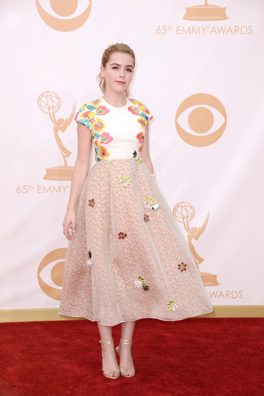 Kiernan Shipka, wearing Delpozi, arrives at the 65th Primetime Emmy Awards at Nokia Theatre on Sunday Sept. 22, 2013, in Los Angeles. (Photo by Dan Steinberg/Invision/AP)