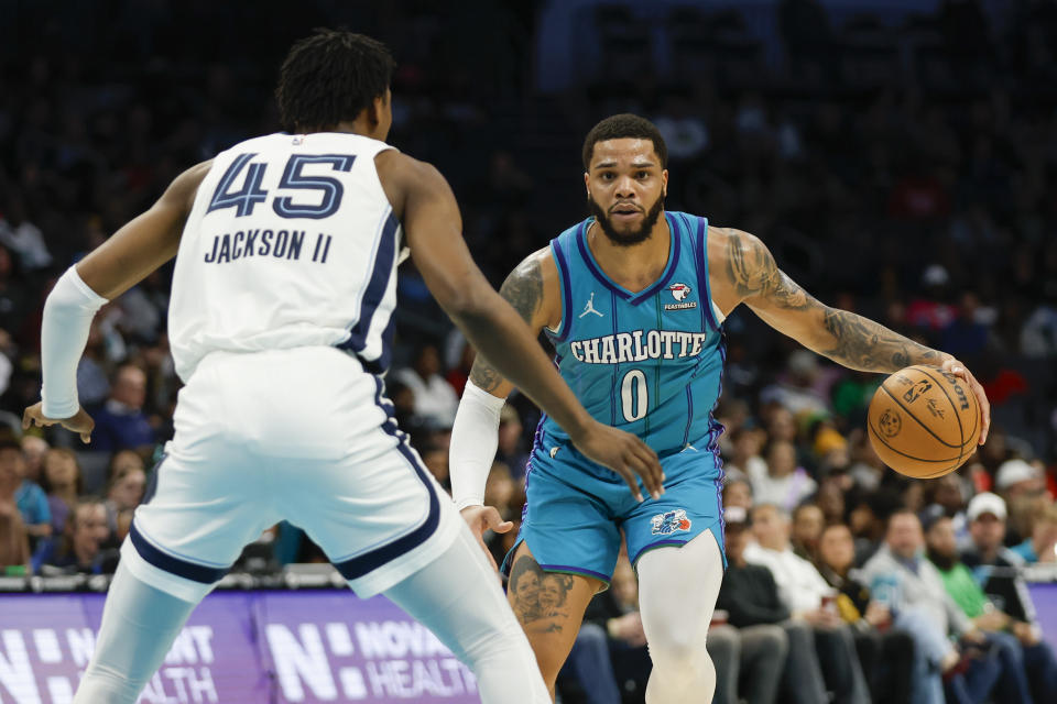 Charlotte Hornets forward Miles Bridges (0) brings the ball upcourt against Memphis Grizzlies forward GG Jackson (45) during the second half of an NBA basketball game in Charlotte, N.C., Saturday, Feb. 10, 2024. (AP Photo/Nell Redmond)