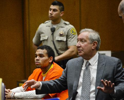 R&B singer Chris Brown appears in court with his attorney Mark Geragos, right, on Thursday, May 1, 2014, in Los Angeles. Superior Court Judge James Brandlin ordered Brown to appear in court again next week to update him on efforts between the singer’s attorney and prosecutors to strike a deal on probation issues in the singer’s 2009 assault case filed after his attack on then-girlfriend Rihanna. (AP Photo/Kevork Djansezian, Pool)