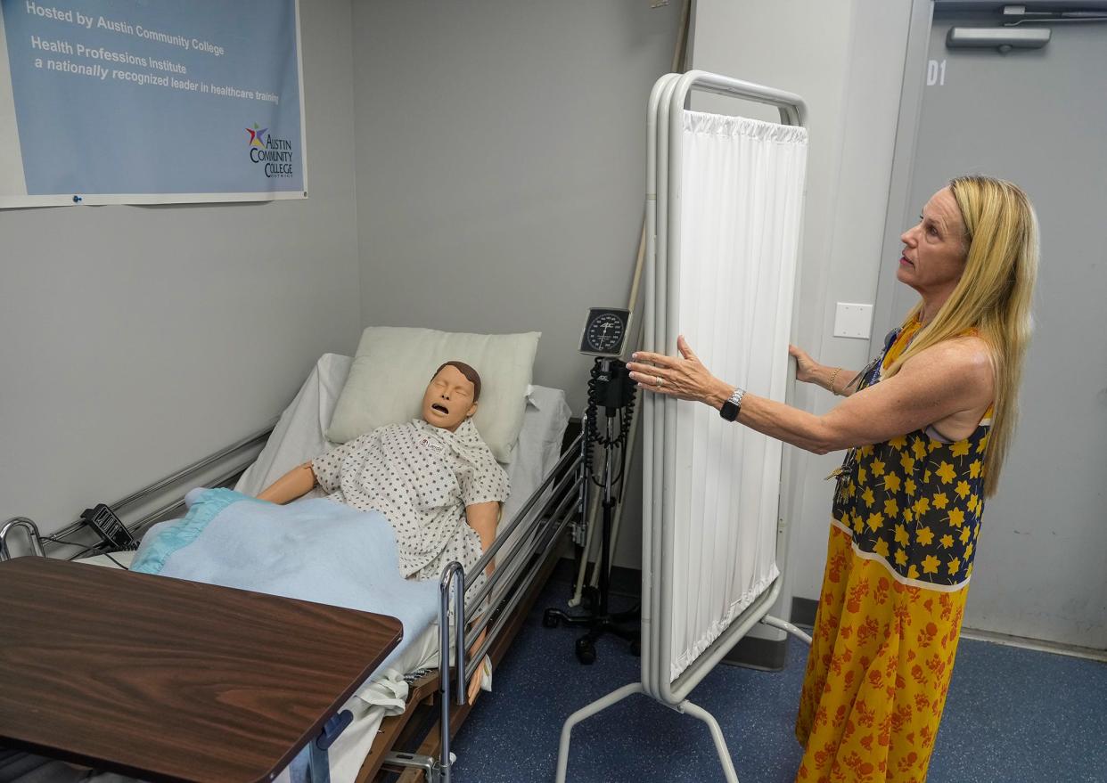 Jackie Uselton shows how students have to move around one health manikin at Westlake High School to work with it. Uselton, health science and clinical instructor, says the Eanes district's $131 million bond proposal would update its facilities for health science classes, among other projects.