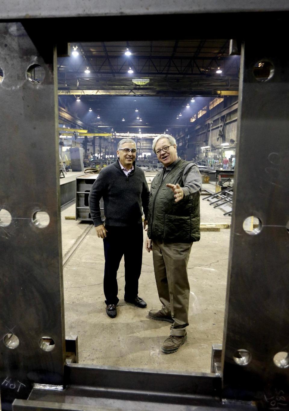 Cedar Fair CEO Matt Ouimet, left, tours the Clermont Steel Fabricating plant with plant representative Bob Mampe, Wednesday, Jan. 9, 2013, in Batavia, Ohio. Ouimet is encouraged about the company's future and the industry and believes one key is keeping people happy. He said the company's new dramatic roller coaster under construction in southwest Ohio will help achieve that goal. (AP Photo/Al Behrman)