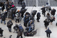 Harvey Weinstein, top right, is photographed by members of the media as leaves court with the aid of a walker at the end of the first day of his trial on rape and sexual assault charges, Wednesday, Jan. 22, 2020, in New York. (AP Photo/Mary Altaffer)