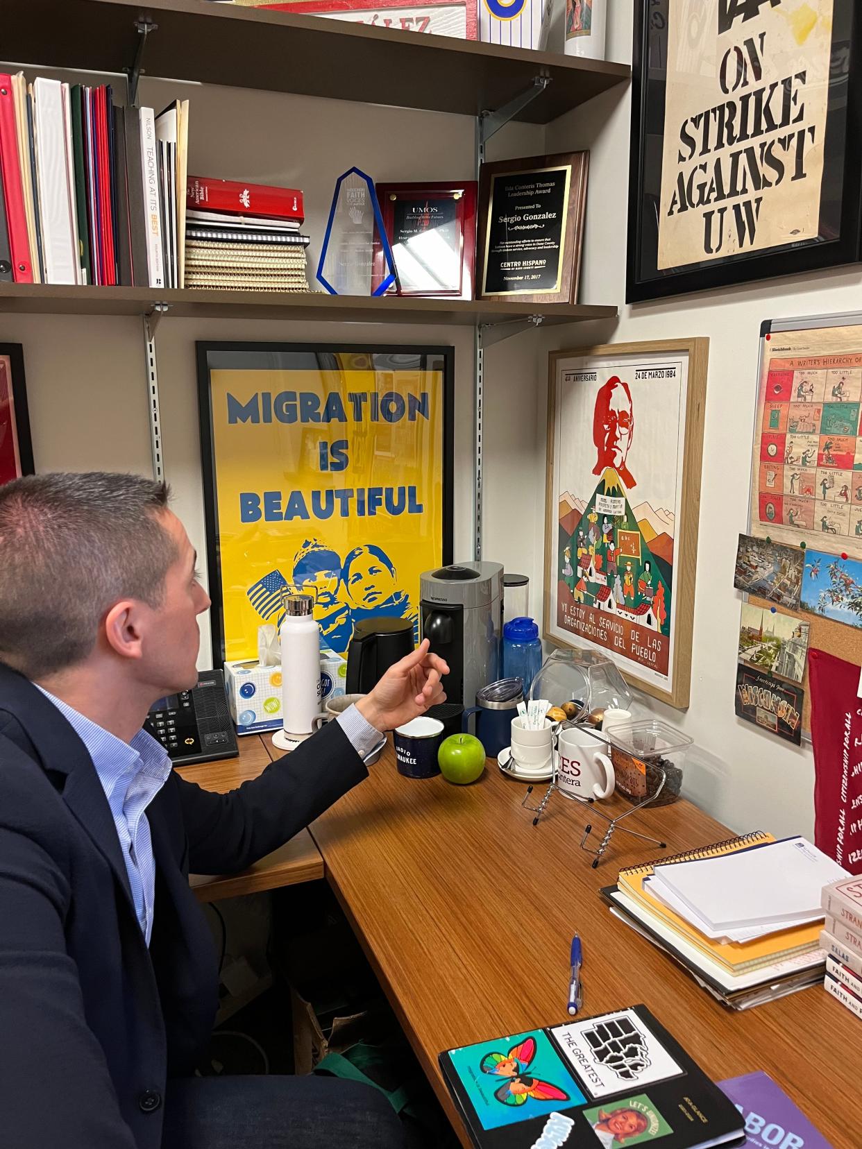 The walls in González's office at Marquette University are lined with Latino centered artwork and books.