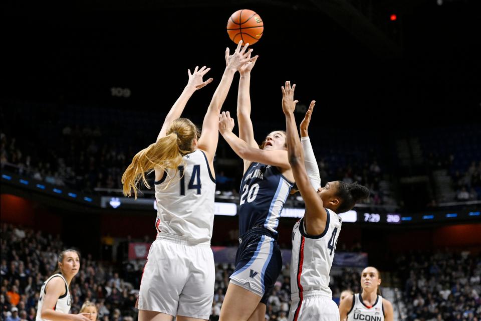 Villanova's Maddy Siegrist (20) shoots between UConn's Dorka Juhasz (14) and UConn's Aubrey Griffin during the first half of an NCAA college basketball game in the finals of the Big East Conference tournament, Monday, March 6, 2023, in Uncasville, Conn. (AP Photo/Jessica Hill)