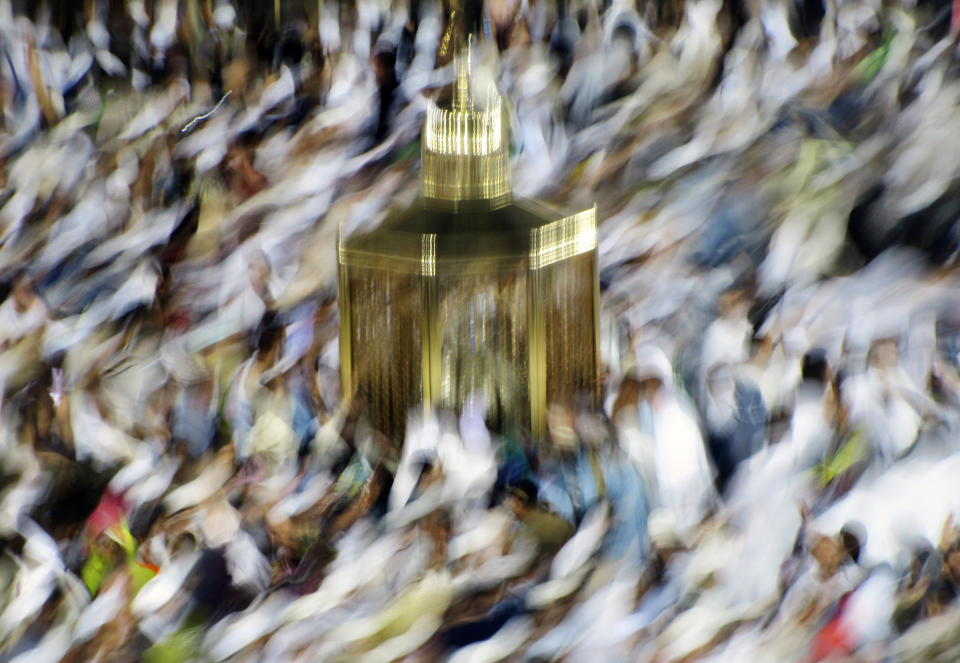 In this picture taken with slow shutter speed, Muslim pilgrims pray past Maqam Ibrahim or The Station of Abraham, the golden glass structure, center, at the Grand Mosque in the Muslim holy city of Mecca, Saudi Arabia, Wednesday, Aug. 7, 2019. Hundreds of thousands of Muslims have arrived in the kingdom to participate in the annual hajj pilgrimage, which starts Saturday, a ritual required of all able-bodied Muslims at least once in their life. (AP Photo/Amr Nabil)