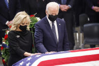 President Joe Biden and first lady Jill Biden touch the casket of former Sen. Bob Dole, who died on Sunday, during a congressional ceremony to honor Dole, who lies in state in the U.S. Capitol Rotunda in Washington, Thursday, Dec. 9, 2021. (Jonathan Ernst/Pool via AP)