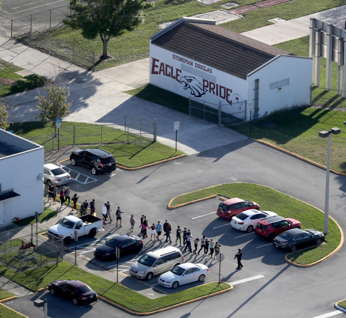Students are evacuated by police out of Stoneman Douglas High School.