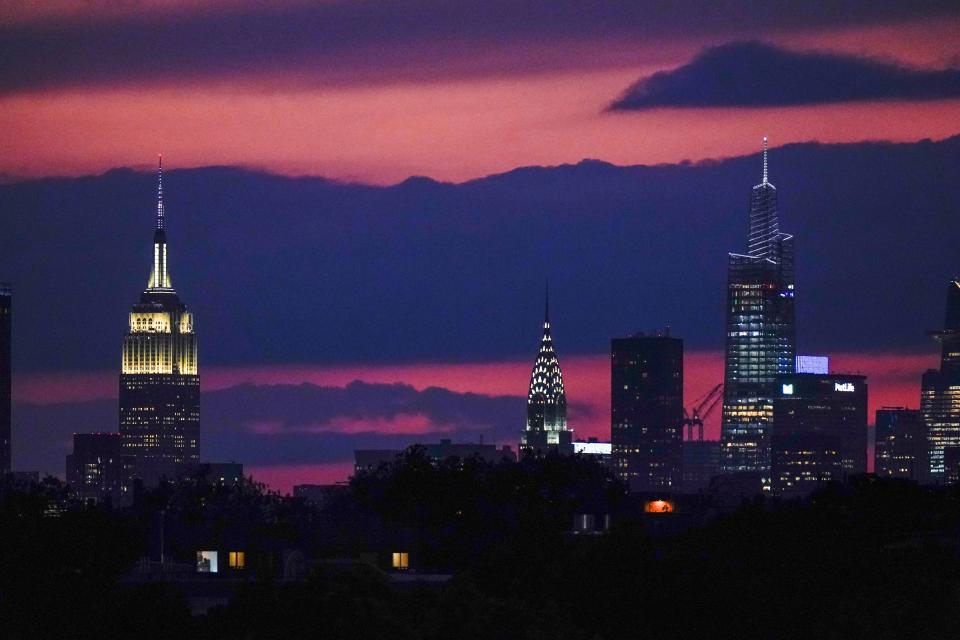 The sun sets behind midtown Manhattan Tuesday, Sept. 28, 2021, in New York. (AP Photo/Frank Franklin II)