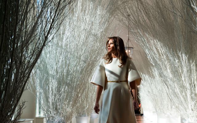 US First Lady Melania Trump walks through Christmas decorations in the East Wing as she tours holiday decorations at the White House in Washington, DC, on November 27, 2017. (Photo by SAUL LOEB / AFP) (Photo by SAUL LOEB/AFP via Getty Images)