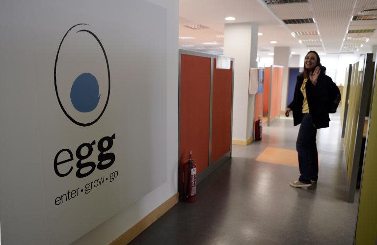 A woman enters her office at the Egg start-up in Athens on November 12, 2014