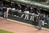 Cleveland Indians wait out a brief suspension of play during the fifth inning after a drone landed in center field, before taking off and flying out of the ballpark during a baseball game between the Chicago Cubs and the Indians on Wednesday, Sept. 16, 2020, in Chicago. (AP Photo/Mark Black)