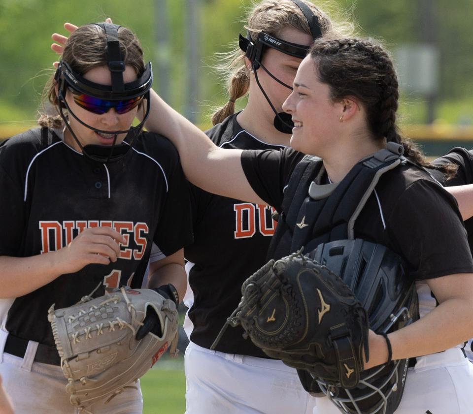 Marlington's Faith Savage, left, is congratulated by catcher Grace Nase after Savage recorded the third out in the seventh inning of a district semifinal win over West Branch, Tuesday, May, 16, 2023.