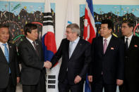 International Olympic Committee (IOC) President Thomas Bach from Germany welcomes South Korean Sports Minister Do Jong-hwan as North Korea's Olympic Committee President and Minister of Physical Culture and Sports Kim Il Guk looks on during a working meeting to discuss further sports cooperation between the Republic of Korea (ROK) and the Democratic People’s Republic of Korea (DPRK) as well as their bid to co-host the 2032 Summer Olympics, at the IOC Headquarters in Lausanne, Switzerland, February 15, 2019. Salvatore Di Nolfi/Pool via REUTERS