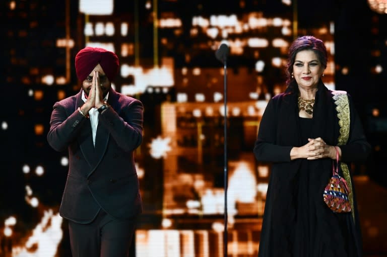 This file photo taken on July 16 shows Bollywood actor Satinder Sartaaj (L) and Shabana Azmi arriving on stage to introduce their movie "The Black Prince" at the 18th International Indian Film Academy Festival