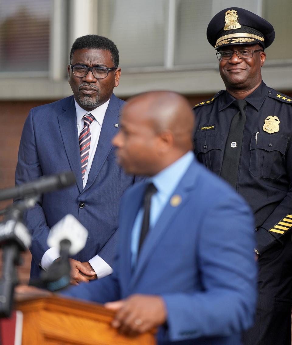 Milwaukee Public Schools Superintendent Keith P. Posley, left, and Police Chief Jeffrey Norman listen as Mayor Cavalier Johnson speaks at Milwaukee High School of the Arts.