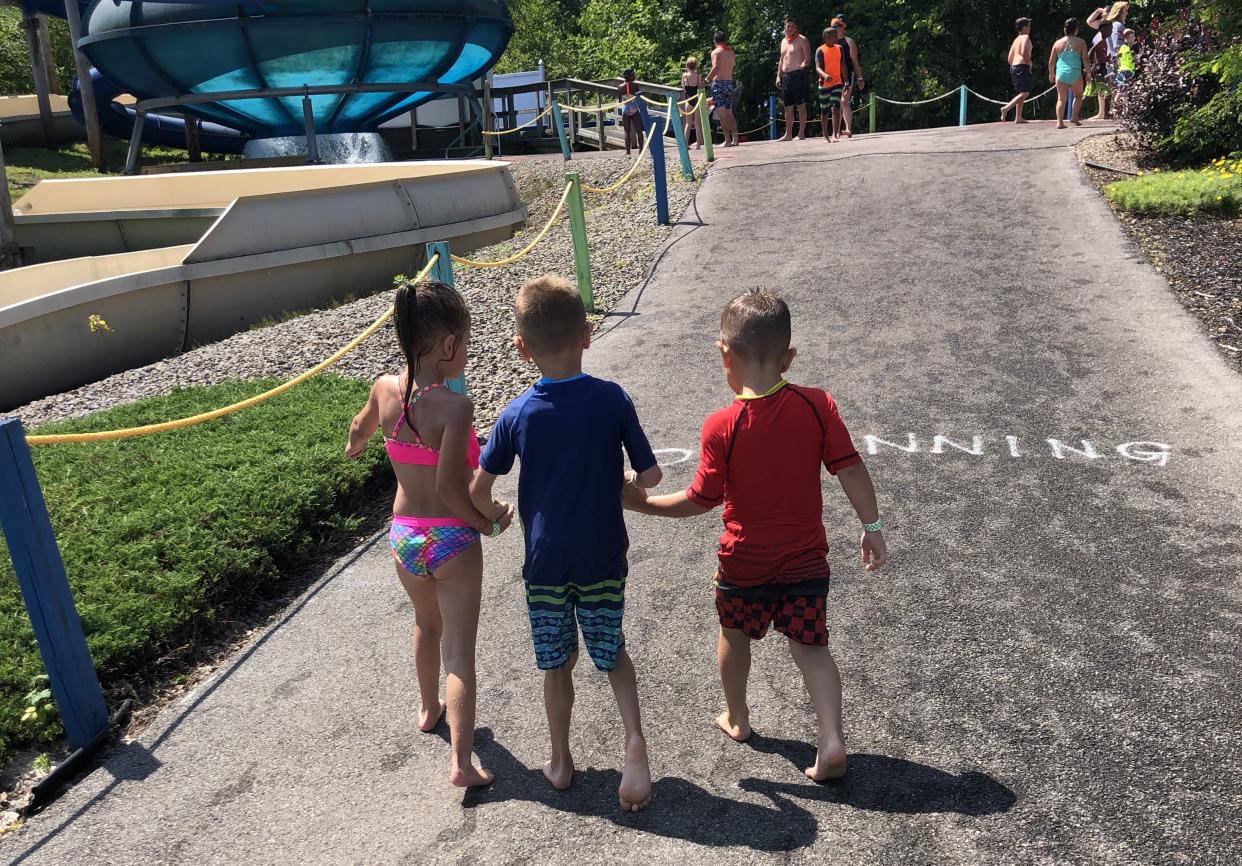 Jeffrey Mackey's two friends Raya and Kane helped him walk throughout the Thunder Island water park in Clay, N.Y. (Credit: Andrea Mackey)