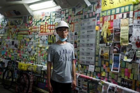 Hong Kong native and Australia resident Jason Tse poses for a portrait in a tunnel adorned with protest notes in Hong Kong