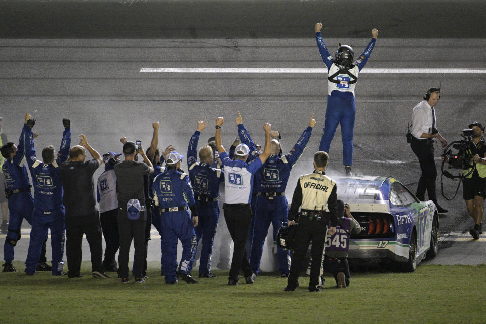 Chris Buescher celebrates on top of his car after winning the NASCAR Cup Series auto race at Daytona International Speedway, Saturday, Aug. 26, 2023, in Daytona Beach, Fla. (AP Photo/Phelan M. Ebenhack)