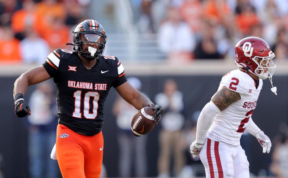 Oklahoma State's Rashod Owens (10) reacts after making a catch alongside Oklahoma State's Billy Bowman Jr. (2) in the second half during a Bedlam college football game between the Oklahoma State University Cowboys (OSU) and the University of Oklahoma Sooners (OU) at Boone Pickens Stadium in Stillwater, Oklahoma, Saturday, November 4, 2023.