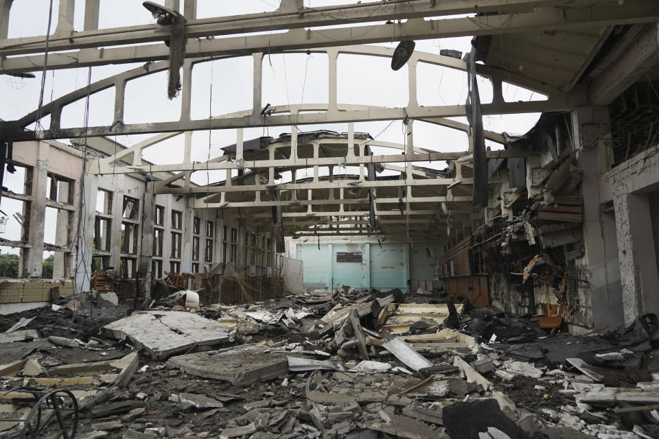 General view of the ruins of the sports complex of the National Technical University in Kharkiv, Ukraine, Friday, June 24, 2022, damaged during a night shelling. The building received significant damage. A fire broke out in one part but firefighters managed to put it out. (AP Photo/Andrii Marienko)