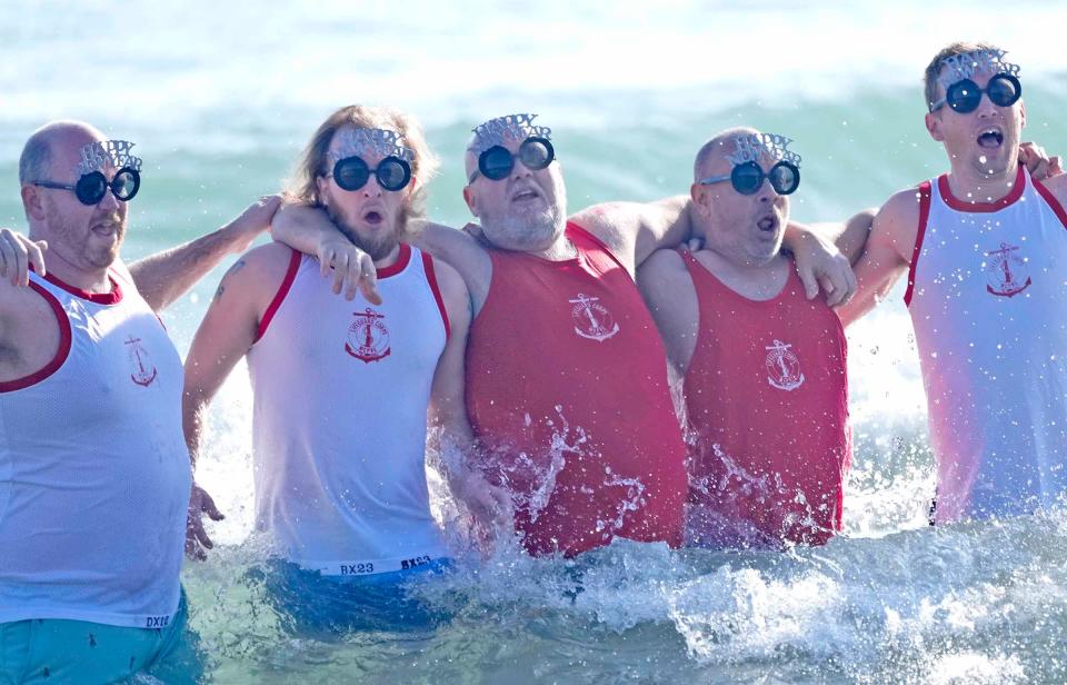 People participate in the annual Polar Bear Plunge on Lake Michigan at Bradford Beach in Milwaukee on New Year’s Day. It’s a tradition that started decades ago. Sunday's wasn't as chilly as some past plunges, with the temperatures above freezing.