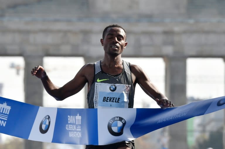 Ethiopian Kenenisa Bekele crosses the finish line past the Brandenburg Gate to win the 43rd Berlin Marathon on September 25, 2016