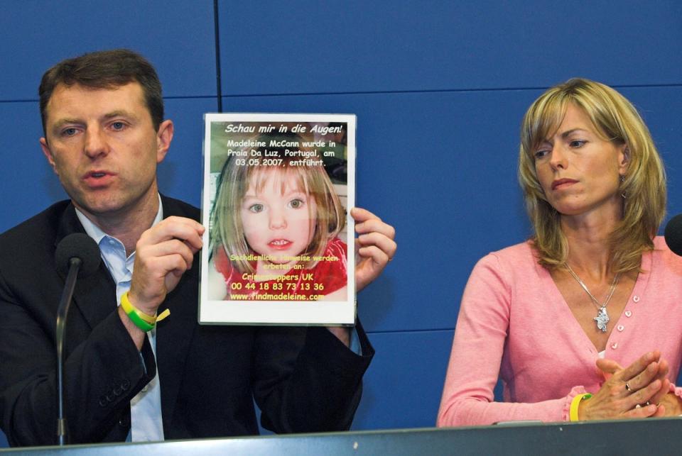 Gerry, left, and Kate McCann, hold up a poster of their four-year old Madeleine (AP)