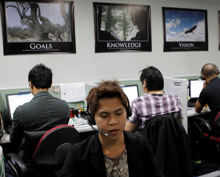 Call center agents work overnight daily to cater to United States clients in Manila's Makati financial district February 6, 2012. REUTERS/Erik De Castro/File Photo