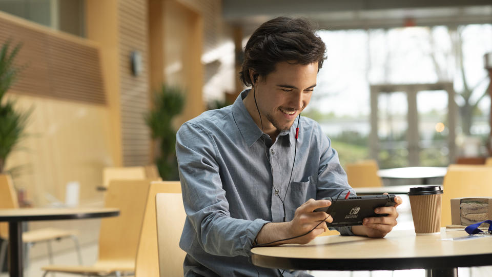 A man plays a game on a Nintendo Switch.