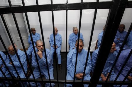 Former intelligence chief of Gaddafi's regime, Abdullah al-Senussisi (2nd row L), and other Gaddafi regime officials sit behind bars during a verdict hearing at a courtroom in Tripoli, Libya July 28, 2015. REUTERS/Ismail Zitouny