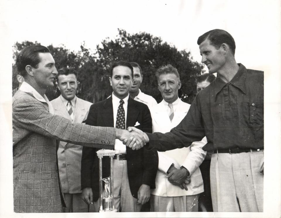 PAUL WANER (LEFT), OUTFIELDER OF THE PITTSBURGH PIRATES AND SOUTHPAW GOLF CHAMPION, SHAKING HANDS WITH JACK RUSSELL, VETERAN AMERICAN LEAGUE PITCHER, WHOM HE DEFEATED IN THE FINAL MATCH OF THE ANNUAL BASEBALL PLAYERS' GOLF TOURNAMENT JAN. 23.