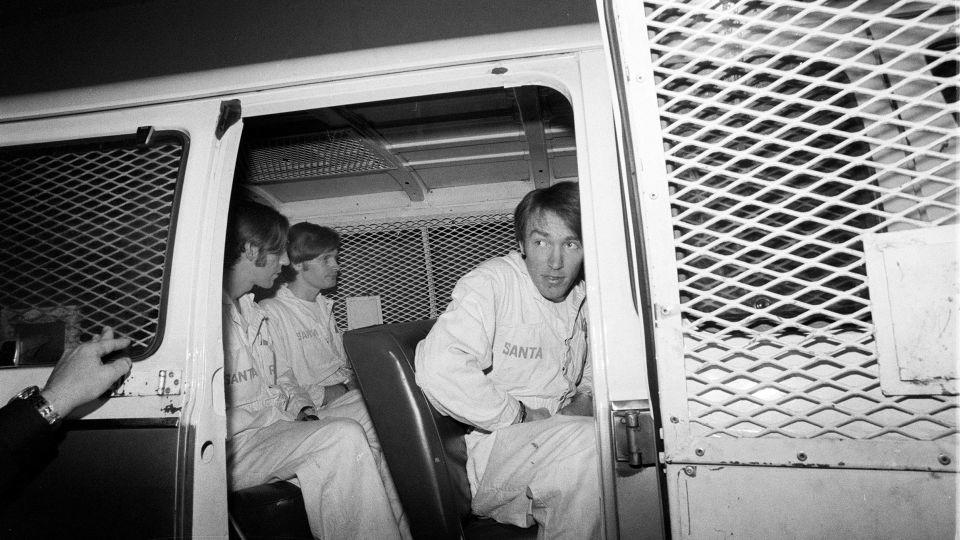 From left, brothers James and Richard Schoenfeld and Fred Woods are taken to prison in 1978. - Joe Rosenthal/San Francisco Chronicle/Getty Images