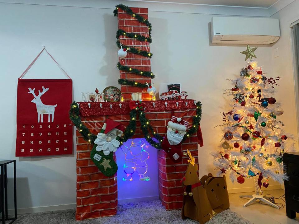 A mum has shared her Christmas hack to create a fireplace in her living room. Photo: Facebook