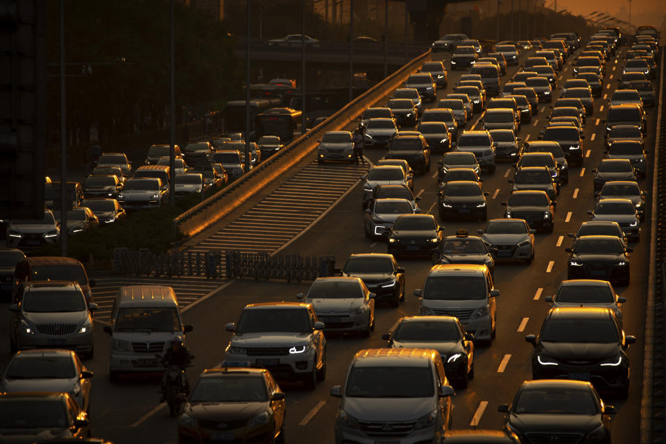 FILE - In this Sept. 6, 2019, file photo, commuters make their way along an expressway during rush hour in Beijing. China's auto sales sank 5.4% in November from a year ago, putting the industry's biggest global market on track to shrink for a second year, an industry group reported Tues, Dec. 10, 2019. Drivers bought just over 2 million SUVs, sedans and minivans, according to the China Association of Automobile Manufacturers. (AP Photo/Mark Schiefelbein, File)