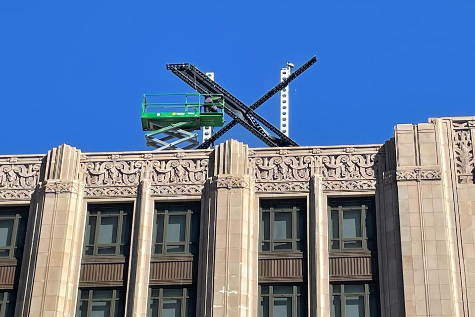 A large, metal "X" sign is seen on top of the downtown building that housed what was once Twitter, now rebranded by its owner, Elon Musk, in San Francisco, Friday, July 28, 2023. The new metal X marker appeared after police stopped workers on Monday, July 24, from removing the iconic bird and logo, saying they didn't have the proper permits and didn't tape off the sidewalk to keep pedestrians safe if anything fell. (AP Photo/Haven Daley)