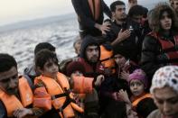 Refugees and migrants arrive at Lesbos island after crossing the Aegean Sea from Turkey on October 8, 2015