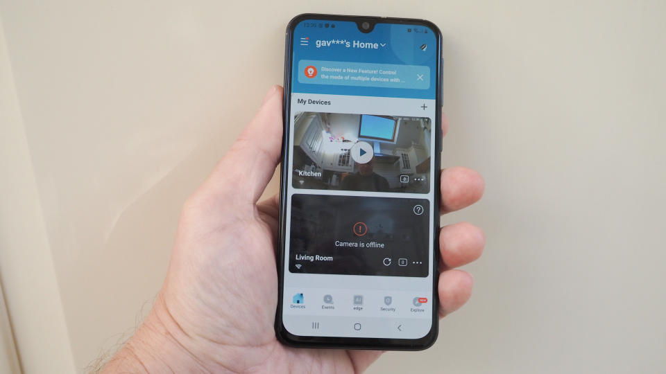 Phone held in a hand showing the app for a Eufy Indoor Cam E220