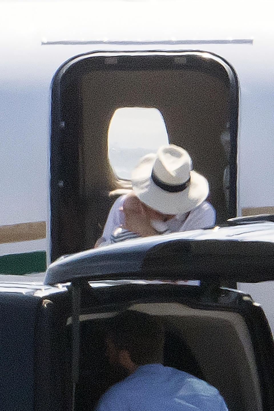 A photo of Meghan Markle holding baby Archie close as she and Harry arrive in Nice, France on August 14, 2019. Photo: MEGA.