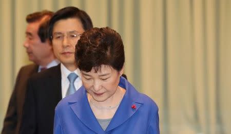 South Korean President Park Geun-hye and Prime Minister Hwang Kyo-ahn arrive to attend an emergency cabinet meeting at the Presidential Blue House in Seoul, South Korea, December 9, 2016. Yonhap/ via REUTERS