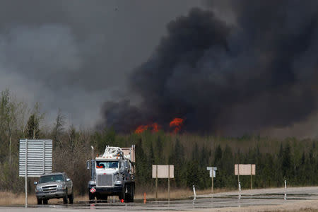 A wildfire burns near Highway 63 south of Fort McMurray, Alberta, Canada, May 6, 2016. REUTERS/Chris Wattie