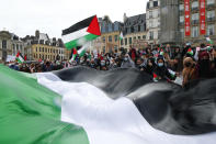 People hold Palestinian flags during a demonstration in Lille, northern France, Saturday May 15, 2021. Marches in support of Palestinians in the Gaza Strip were being held Saturday in a dozen French cities, but the focus was on Paris, where riot police got ready as organizers said they would defy a ban on the protest. (AP Photo/Michel Spingler)