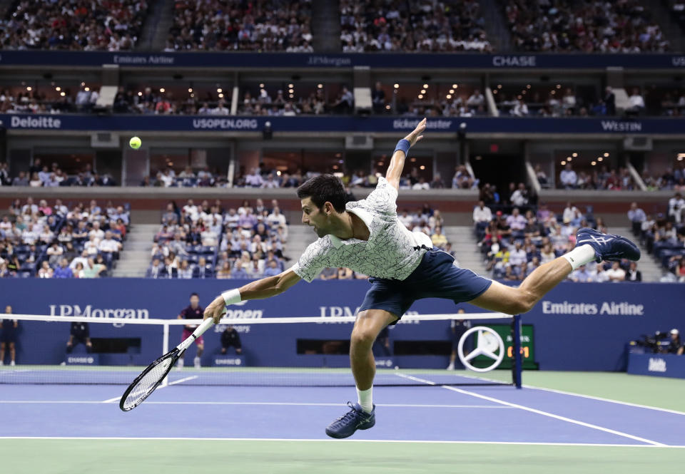 Novak Djokovic, of Serbia, returns a shot to Kei Nishikori, of Japan, during the semifinals of the U.S. Open tennis tournament, Friday, Sept. 7, 2018, in New York. (AP Photo/Andres Kudacki)