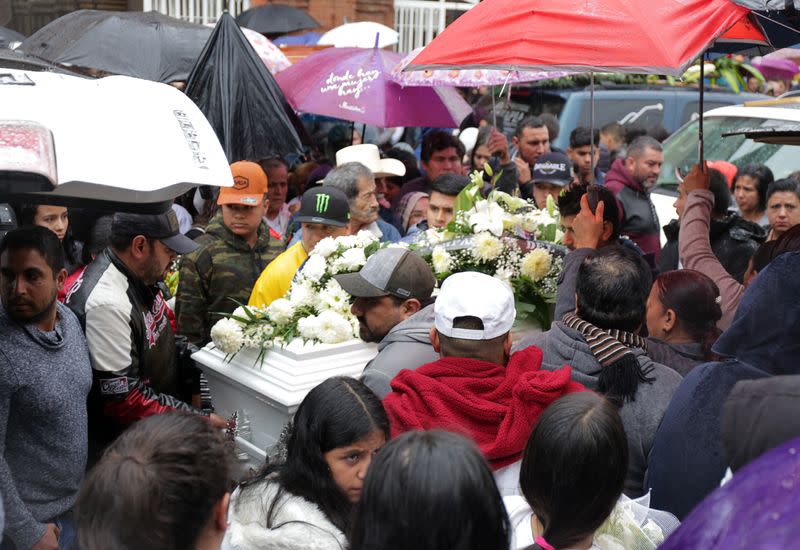 People attend the funeral of several of the victims killed by shooters at a slot-machine arcade in the central Mexican state of Michoacan, in Uruapan