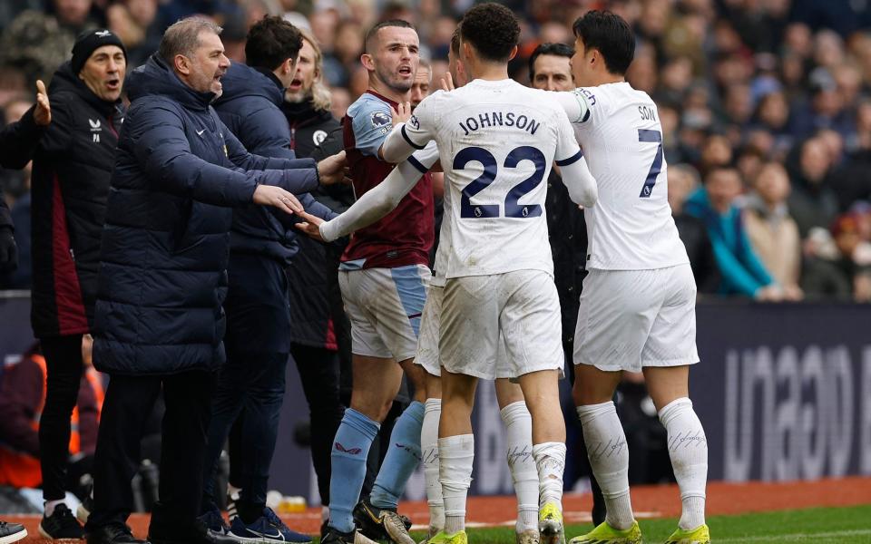 Aston Villa's John McGinn clashes with Tottenham Hotspur's Brennan Johnson before being shown a red card