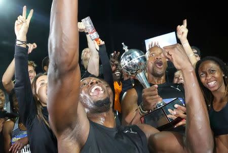 Jamaica's Olympic champion Usain Bolt celebrates with team mates as the pose with the trophy during the final night of the Nitro Athletics series at the Lakeside Stadium in Melbourne, Australia, February 11, 2017. REUTERS/Hamish Blair