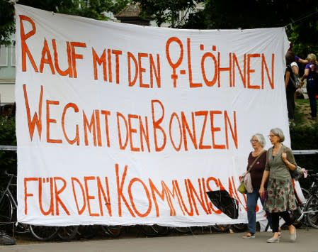 Women walk past a banner during the women's strike in Zurich
