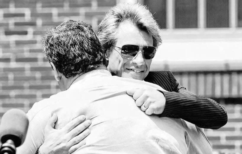 Jon Bon Jovi hugs Gov. Chris Christie prior to donating $1 million to superstorm Sandy relief during a ceremony in his hometown of Sayreville.