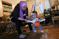 Yasmina al-Habbal, plays with Ghlaya, an orphan she sponsors, at her home in Cairo