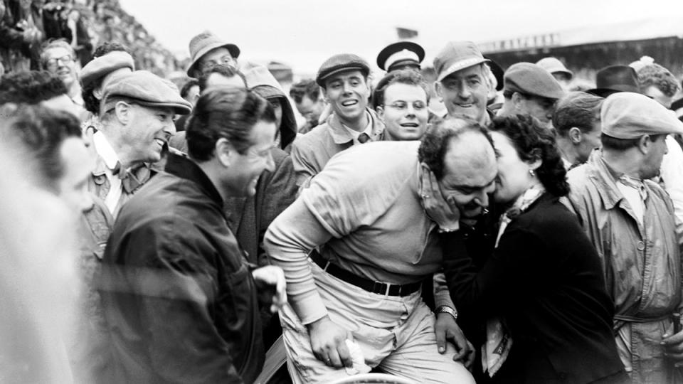 Ferrari's José Froilán González, a stocky driver dubbed "the Pampas Bull," receives a kiss from his wife after winning the 1954 British Grand Prix.